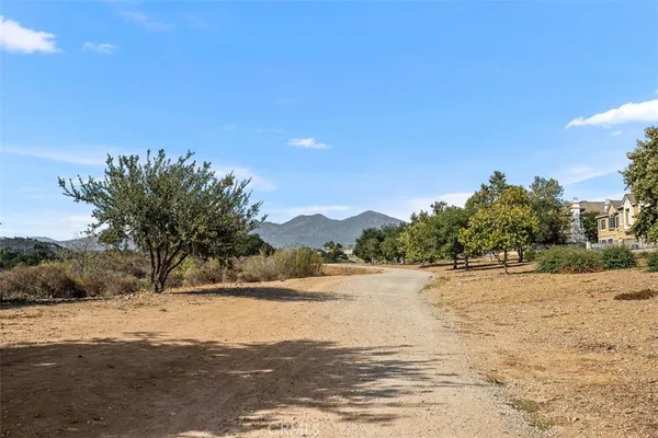 a view of a road with mountains in the background