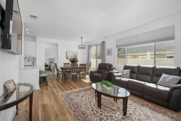 a living room with furniture a rug and a flat screen tv