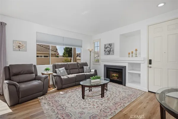 a living room with furniture and a fireplace