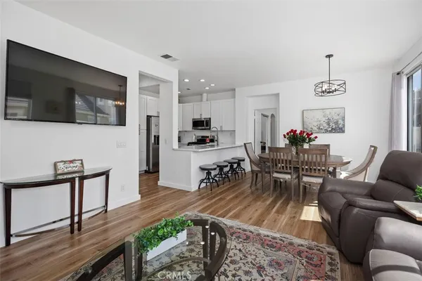 a living room with furniture a rug and a flat screen tv
