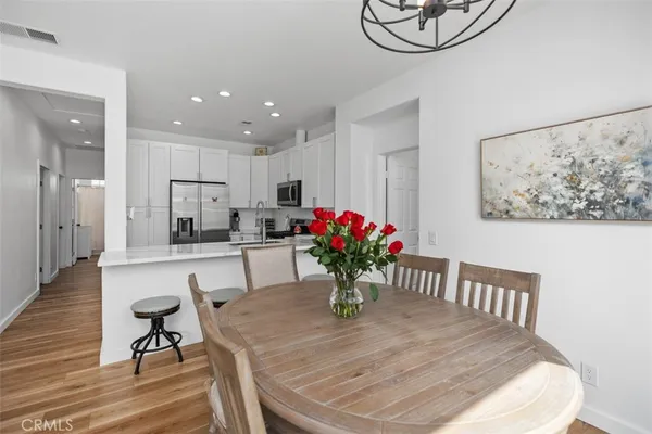 a kitchen with dining table furniture appliances and kitchen view