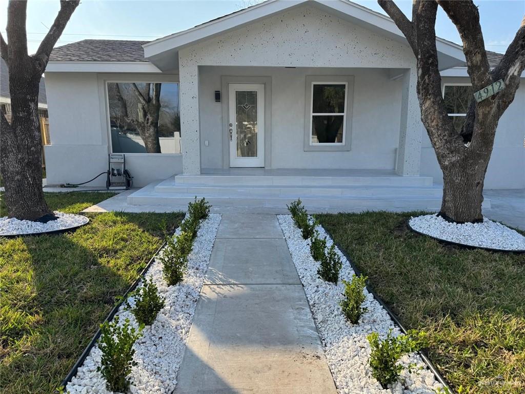 4912 South 36th Street McAllen, TX 78503 - Photo 1 of 15 a front view of a house with garden