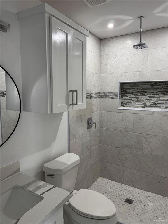 4912 South 36th Street McAllen, TX 78503 - Photo 12 of 15 a bathroom with a toilet a sink and shower