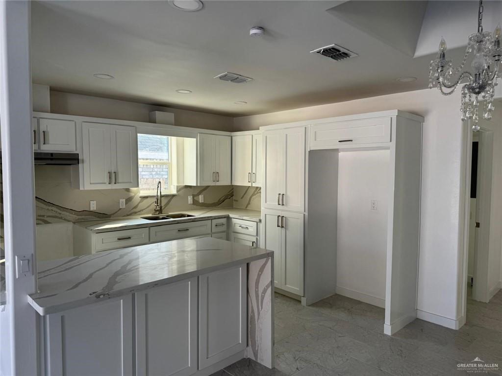 4912 South 36th Street McAllen, TX 78503 - Photo 4 of 15 a kitchen with a sink a stove a refrigerator and cabinets