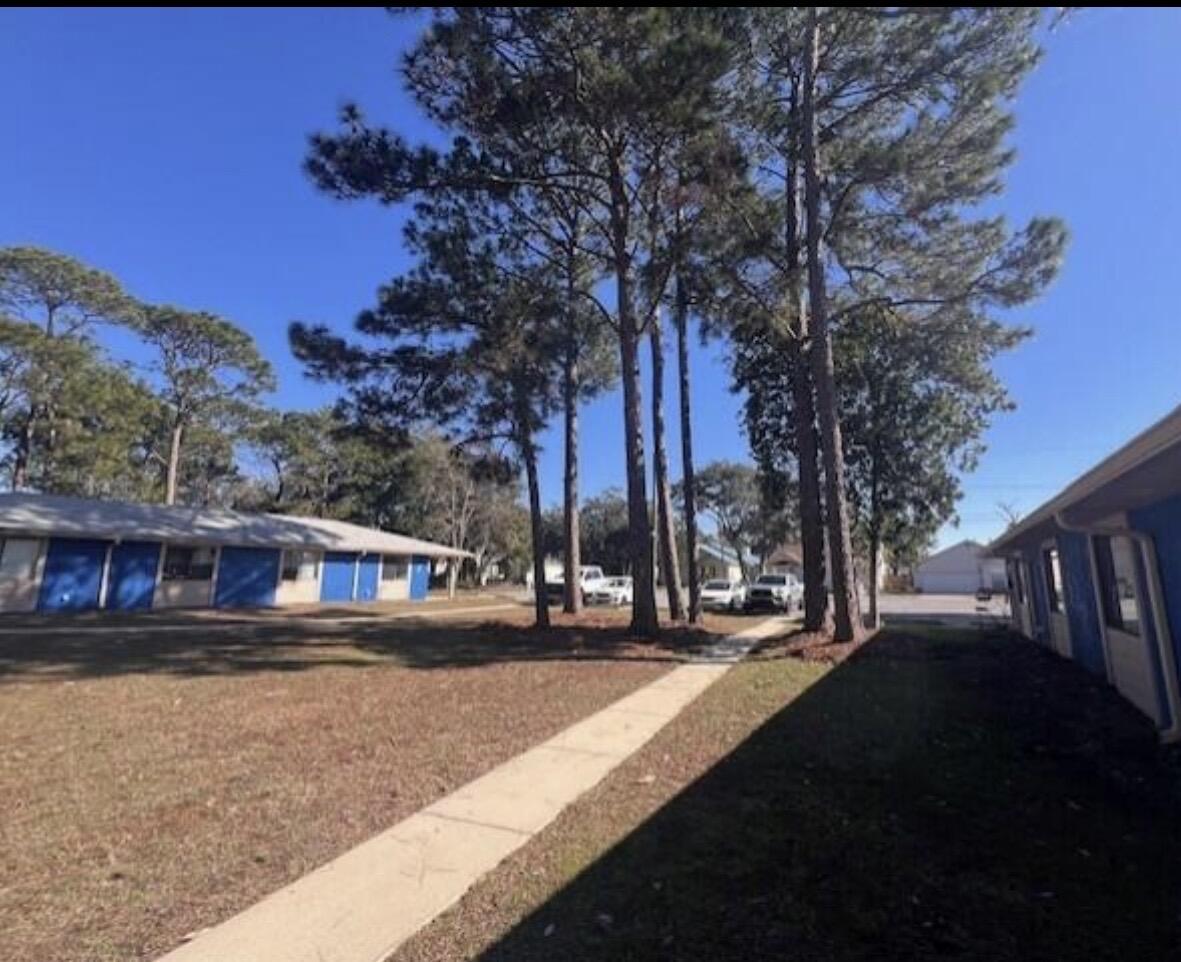 1925 Esplanade Street, Unit F Navarre, FL 32566 - Photo 3 of 13 a view of city street with a house