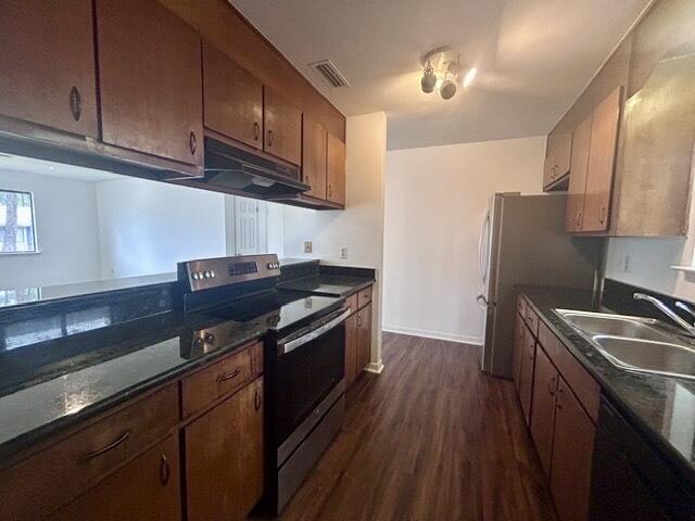 1925 Esplanade Street, Unit F Navarre, FL 32566 - Photo 4 of 13 a kitchen with granite countertop a sink a stove and refrigerator