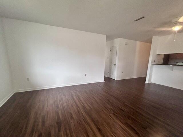 1925 Esplanade Street, Unit F Navarre, FL 32566 - Photo 10 of 13 an empty room with wooden floor and cabinet
