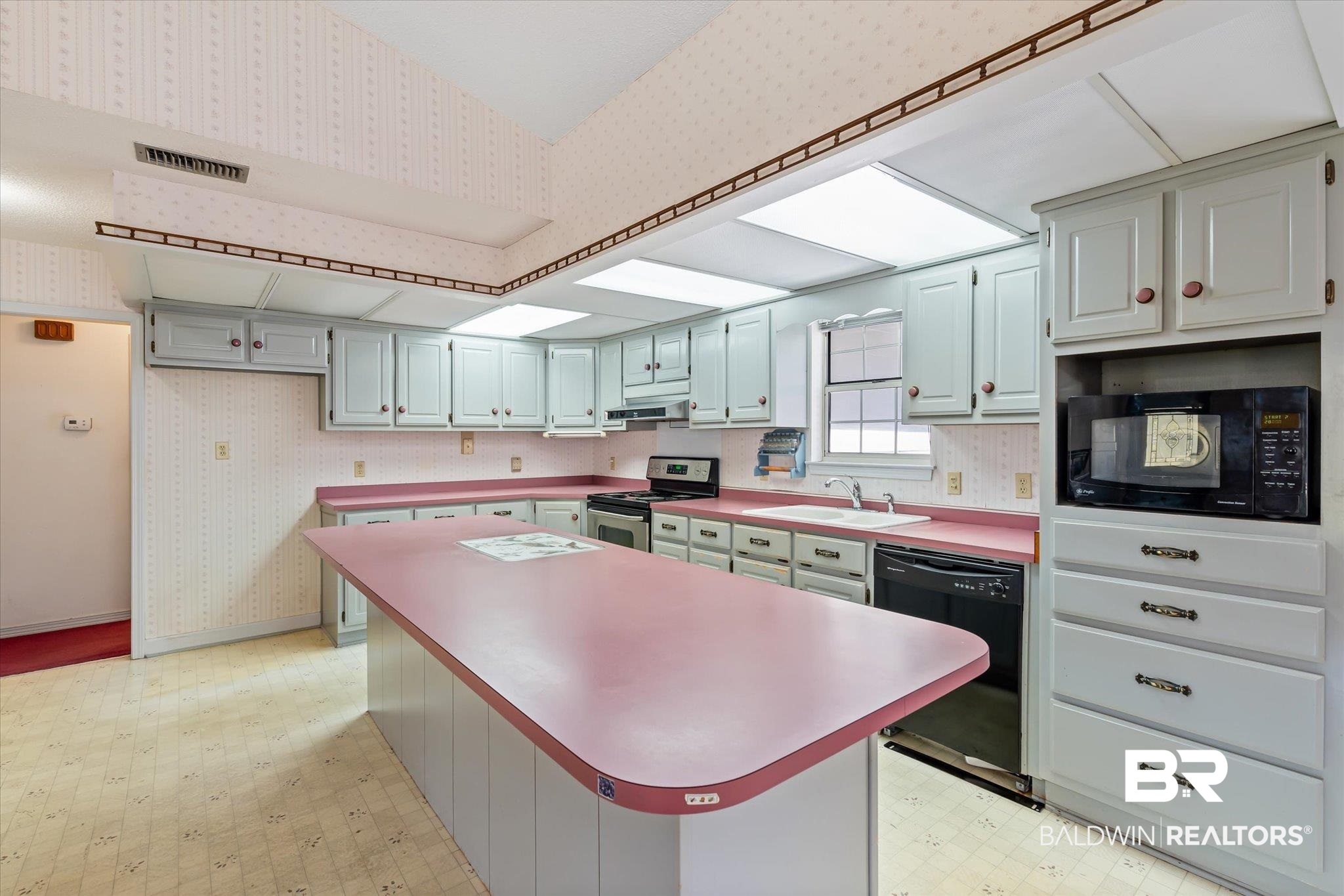 6030 Lott Road Eight Mile, AL 36613 - Photo 8 of 21 Kitchen featuring a sink, wallpapered walls, black appliances, and light floors