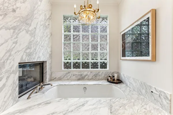 a bathroom with a tub sink and window