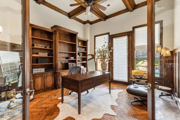 a view of a livingroom with workspace and a window