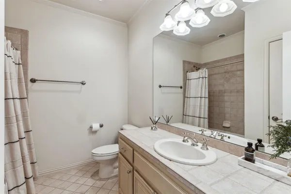 a bathroom with a granite countertop sink a toilet and a mirror