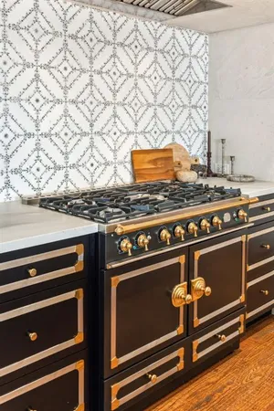 a stove top oven sitting inside of a kitchen