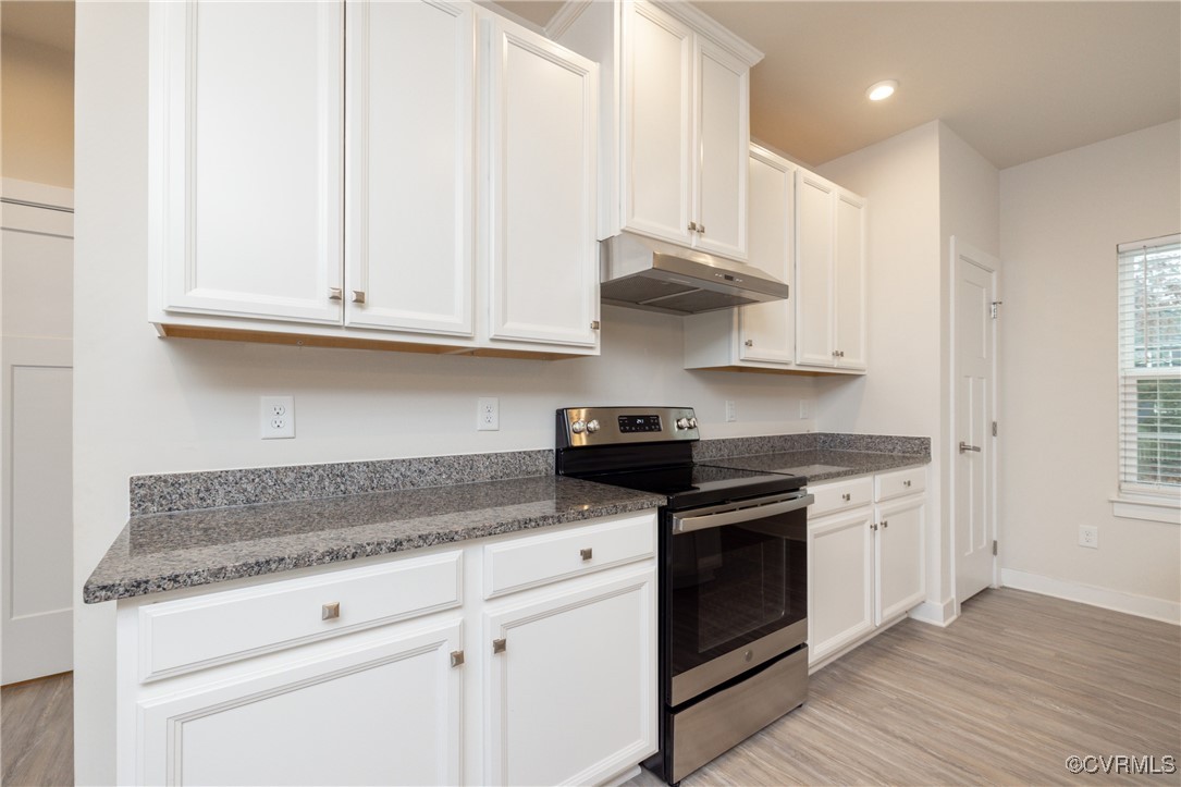 13900 Marsham Road Chester, VA 23836 - Photo 11 of 46 a kitchen with stainless steel appliances granite countertop a stove a sink and white cabinets