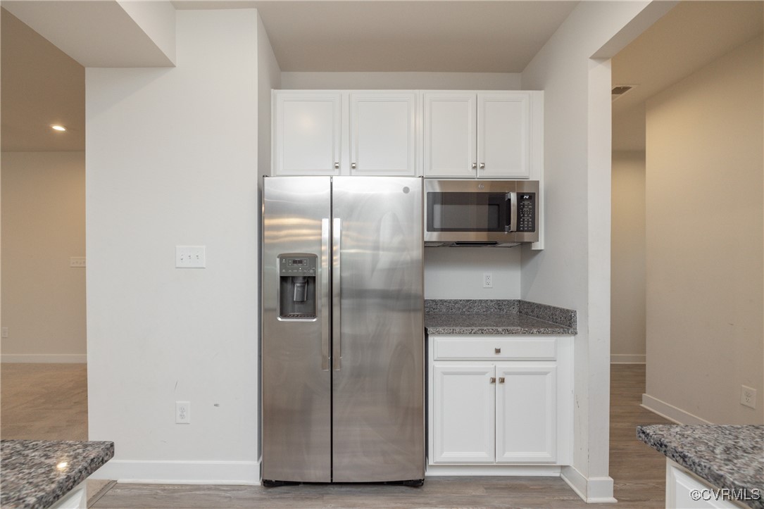 13900 Marsham Road Chester, VA 23836 - Photo 12 of 46 a metallic refrigerator freezer sitting in a kitchen