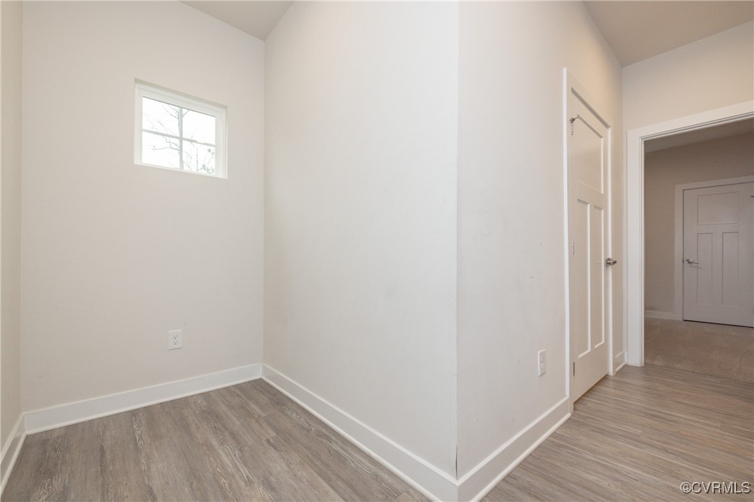13900 Marsham Road Chester, VA 23836 - Photo 20 of 46 a view of an empty room with wooden floor and a window