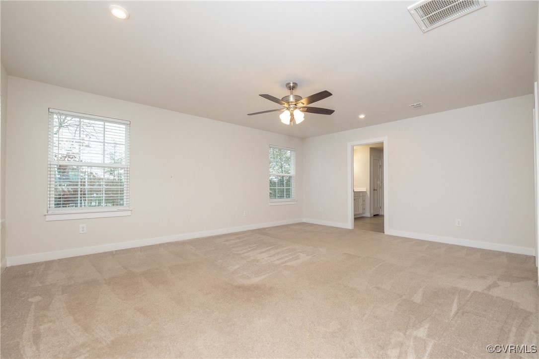 13900 Marsham Road Chester, VA 23836 - Photo 34 of 46 an empty room with chandelier fan and windows