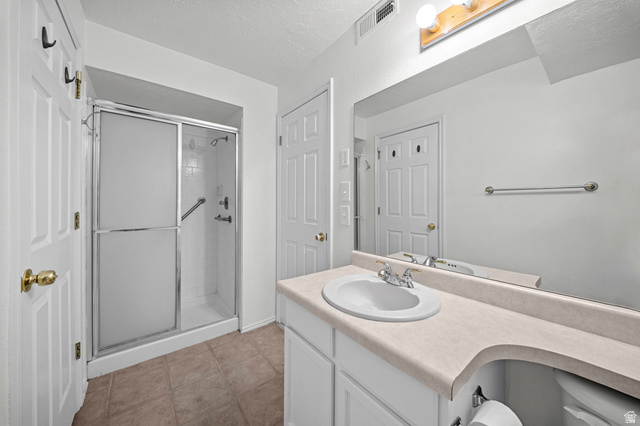 11934 South Cedar Ridge Road Sandy, UT 84094 - Photo 34 of 58 White vanity with an integrated sink, polished chrome faucet, and expansive wall-mounted mirror