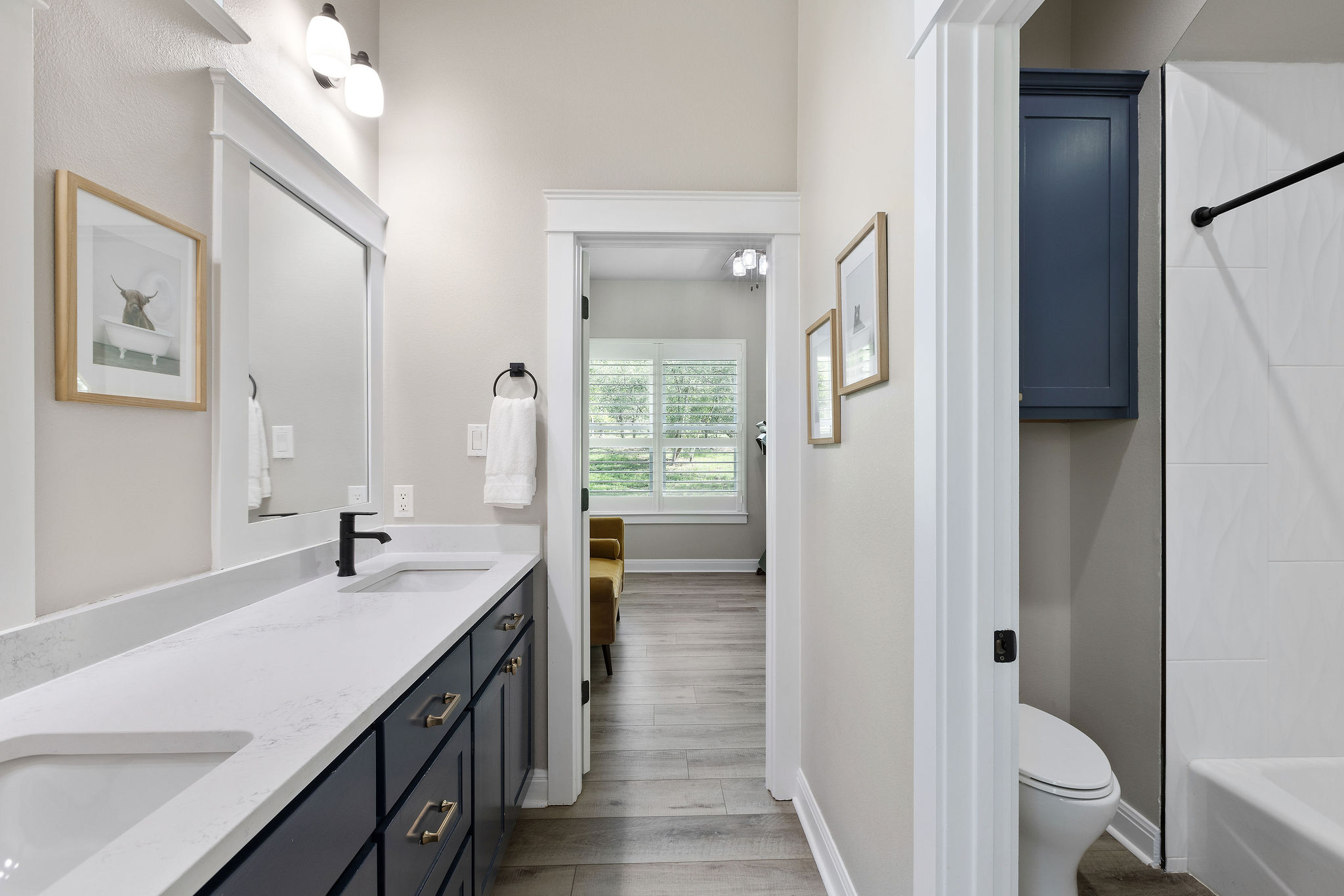 279 Rugged Earth Drive Austin, TX 78737 - Photo 34 of 40 a bathroom with a double vanity sink a toilet and a mirror
