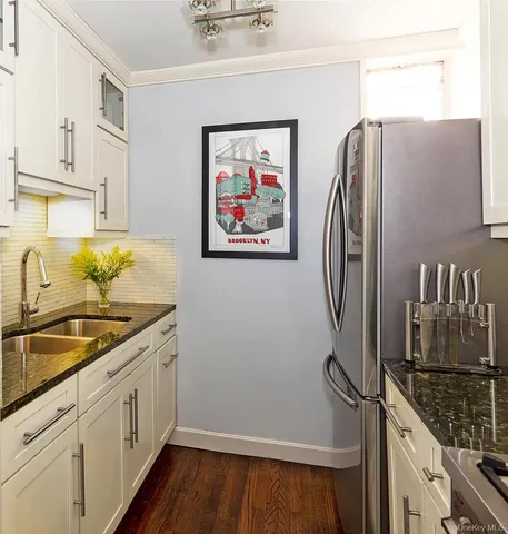 a kitchen with stainless steel appliances a refrigerator and a sink