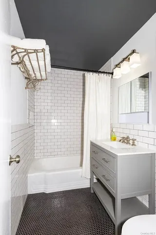 a bathroom with a bathtub and a shower