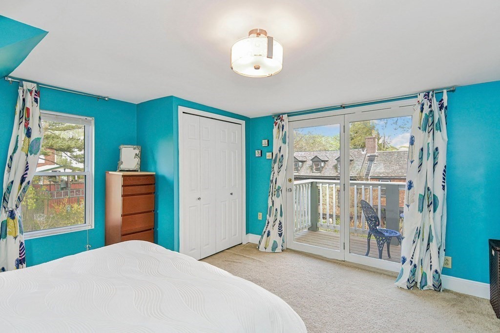 56 Main Street Hull, MA 02045 - Photo 18 of 34 a bedroom with a bed and a chandelier