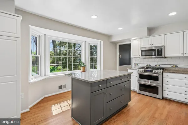 a kitchen with stainless steel appliances granite countertop a stove and a sink