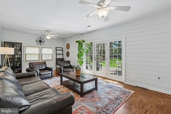 a living room with furniture and large window