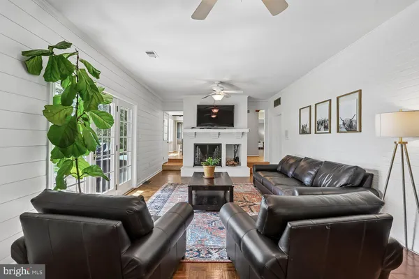 a living room with furniture fireplace and potted plant