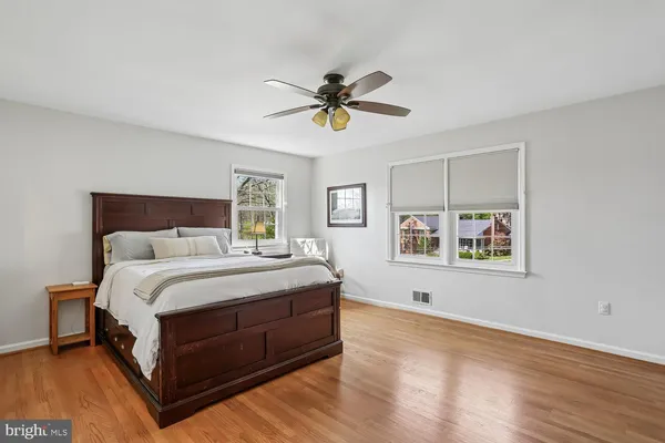 a spacious bedroom with a bed and painting on the wall