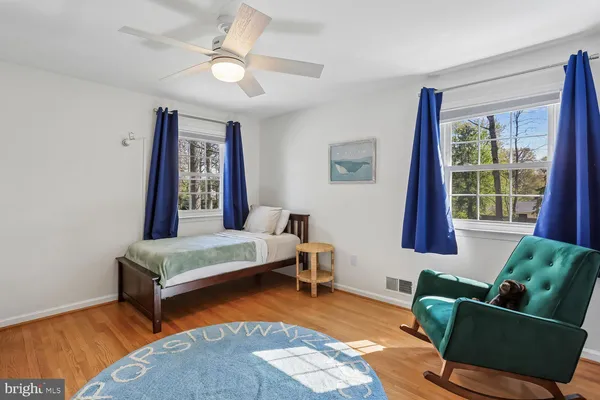 a bedroom with furniture and a wooden floor