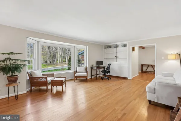 a view of a livingroom with furniture and a large window