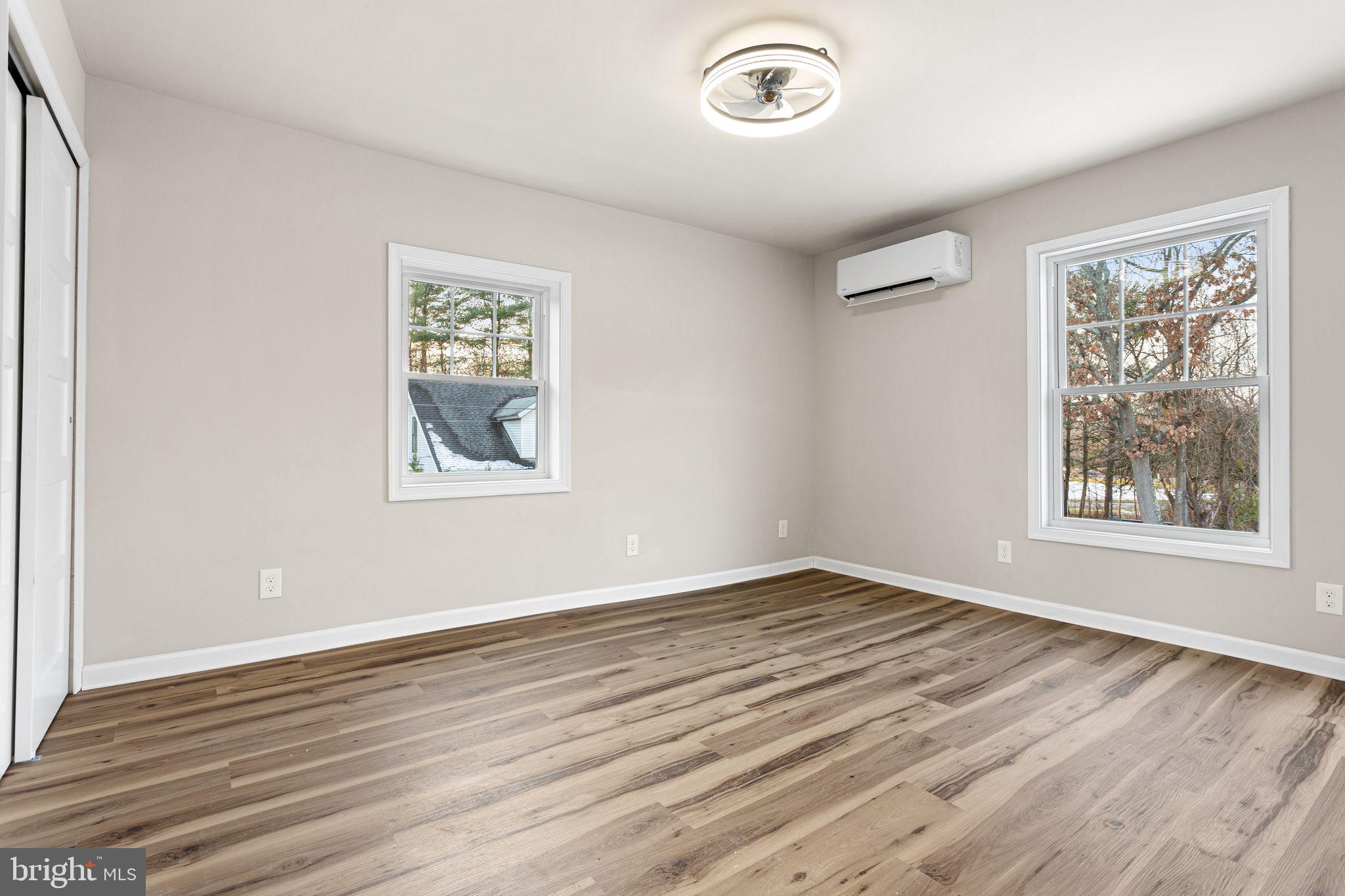 595 Church Road Sewell, NJ 08080 - Photo 20 of 32 a view of an empty room with wooden floor and a window