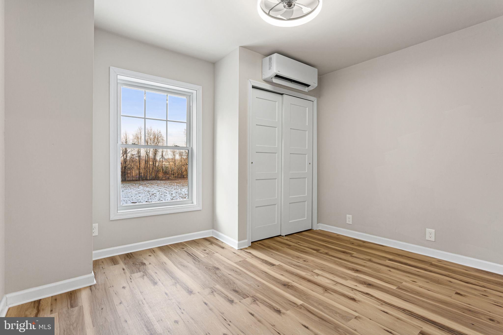 595 Church Road Sewell, NJ 08080 - Photo 22 of 32 an empty room with wooden floor and windows