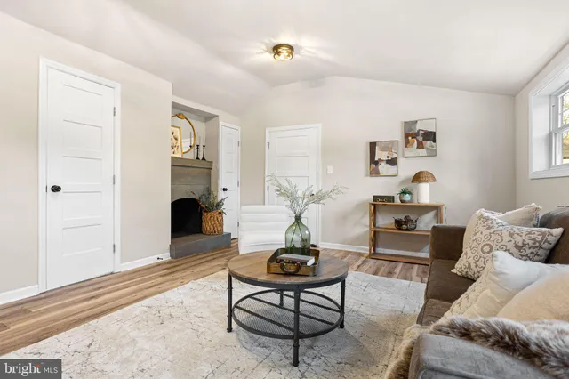 a living room with furniture a rug and a window