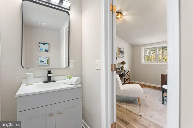 a en suite bathroom with a sink mirror and vanity