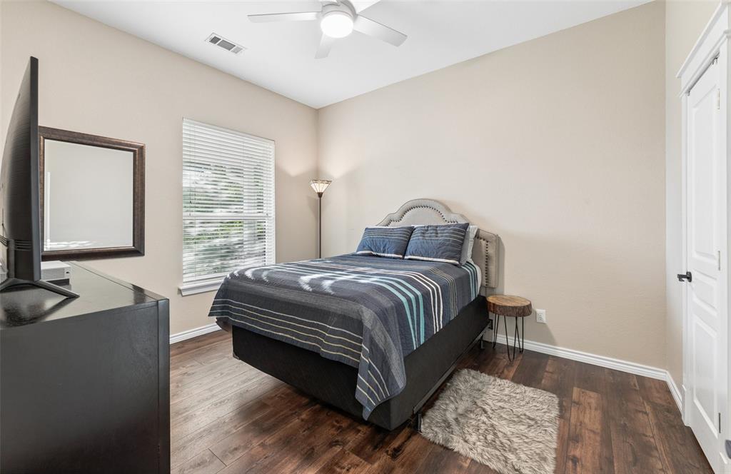 492 County Road 4387 Decatur, TX 76234 - Photo 20 of 40 a bedroom with a bed and a chandelier