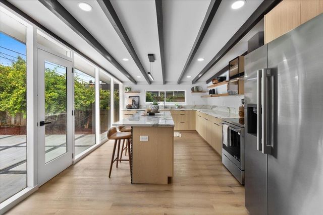 a kitchen with a sink a stove and cabinets