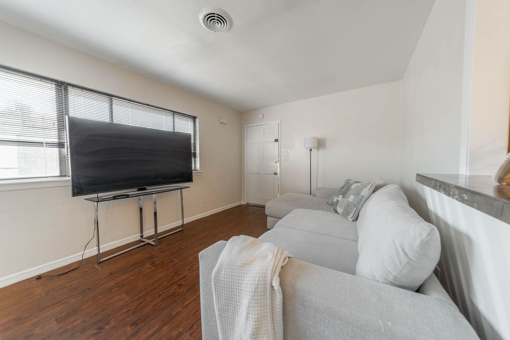 4723 Merwin Street Houston, TX 77027 - Photo 4 of 29 a living room with furniture and a flat screen tv