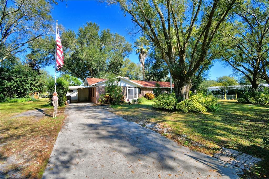 5808 Vaughn Road Bartow, FL 33830 - Photo 1 of 1 a front view of a house with a yard and tree s