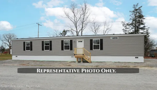 a view of a white house with a yard and stairs