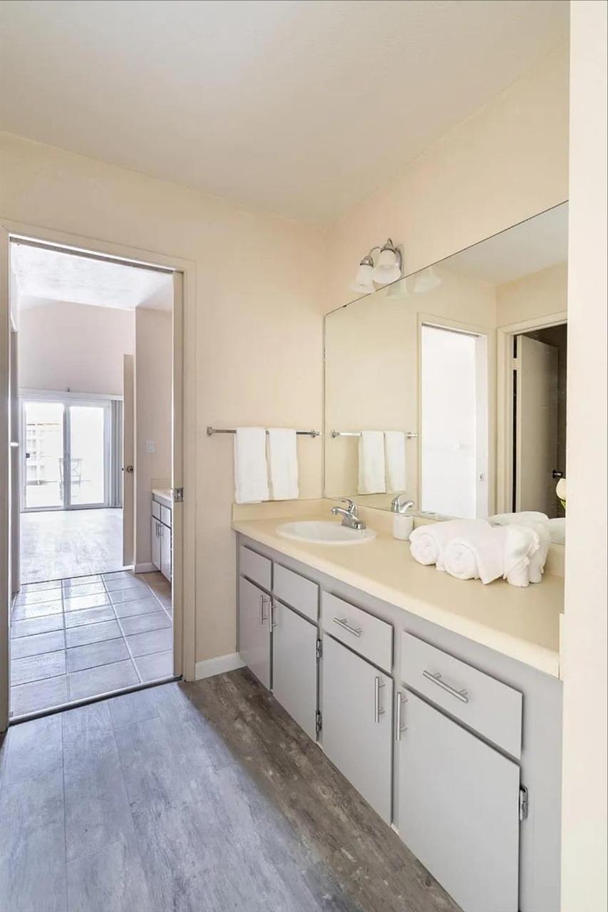 1504 Pierce Drive, Unit 102 Clovis, CA 93612 - Photo 11 of 20 a spacious bathroom with a granite countertop sink mirror and
