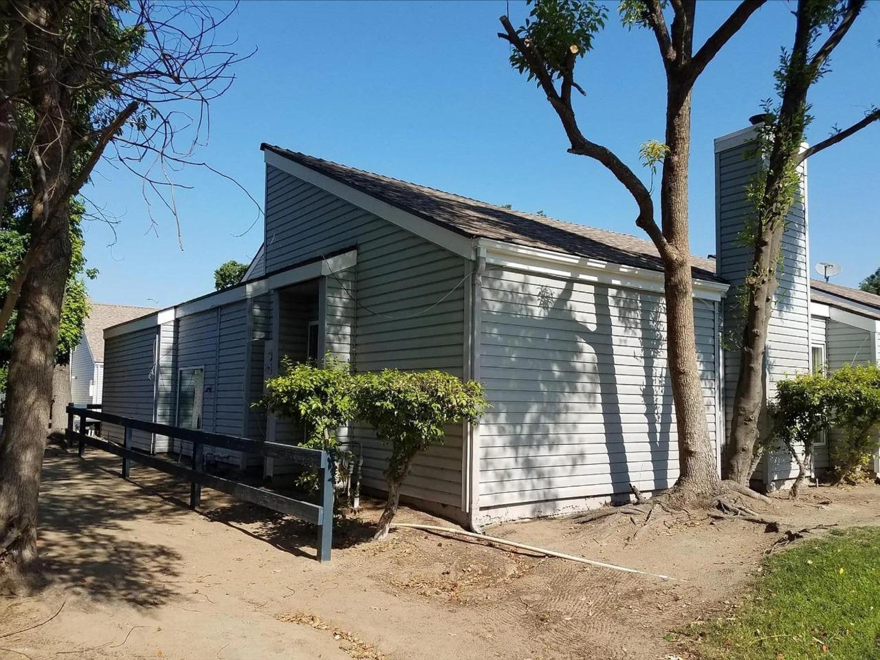 1504 Pierce Drive, Unit 102 Clovis, CA 93612 - Photo 20 of 20 a view of backyard with potted plants and a large tree