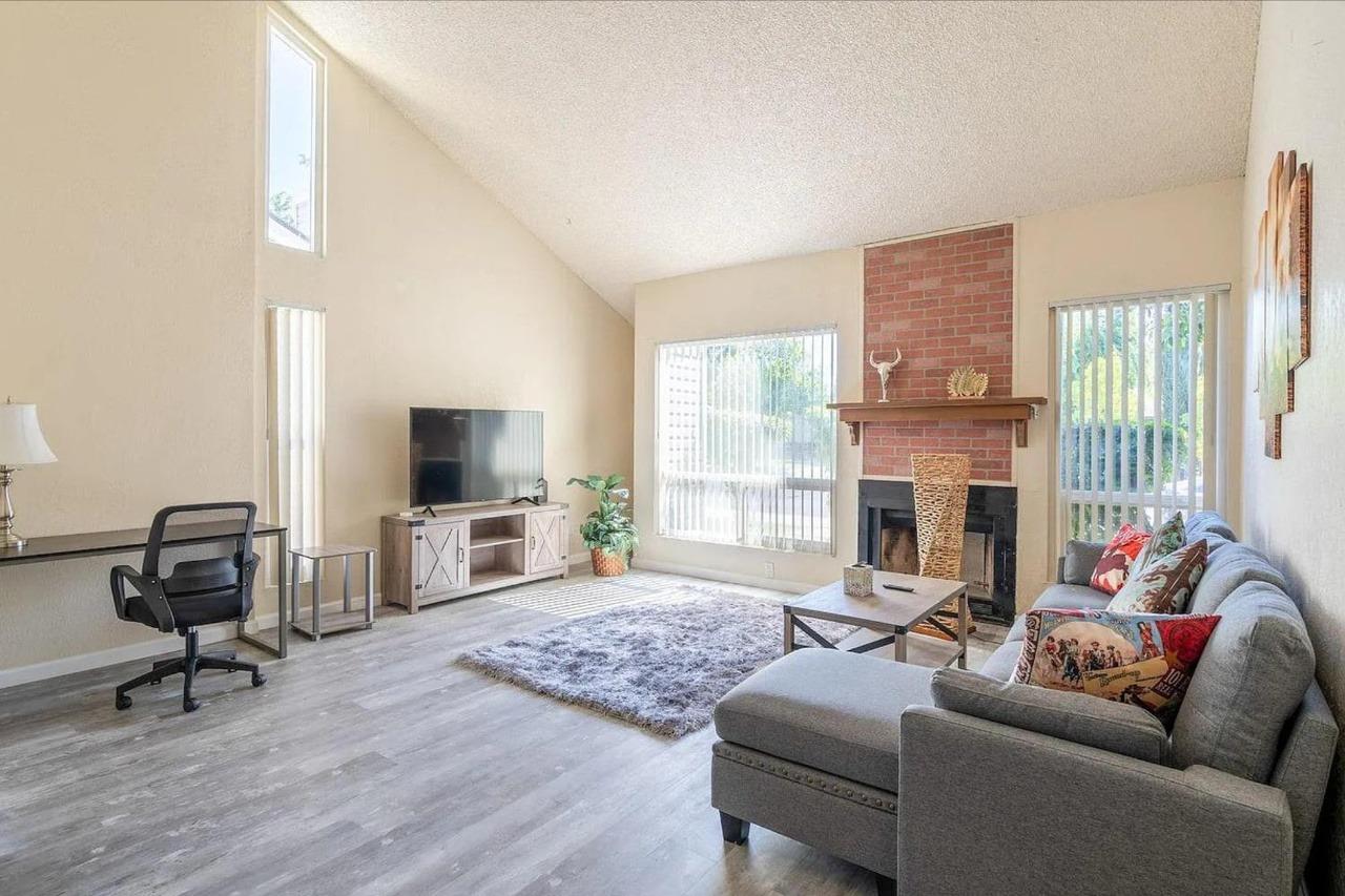 1504 Pierce Drive, Unit 102 Clovis, CA 93612 - Photo 2 of 20 a living room with furniture fireplace and a flat screen tv