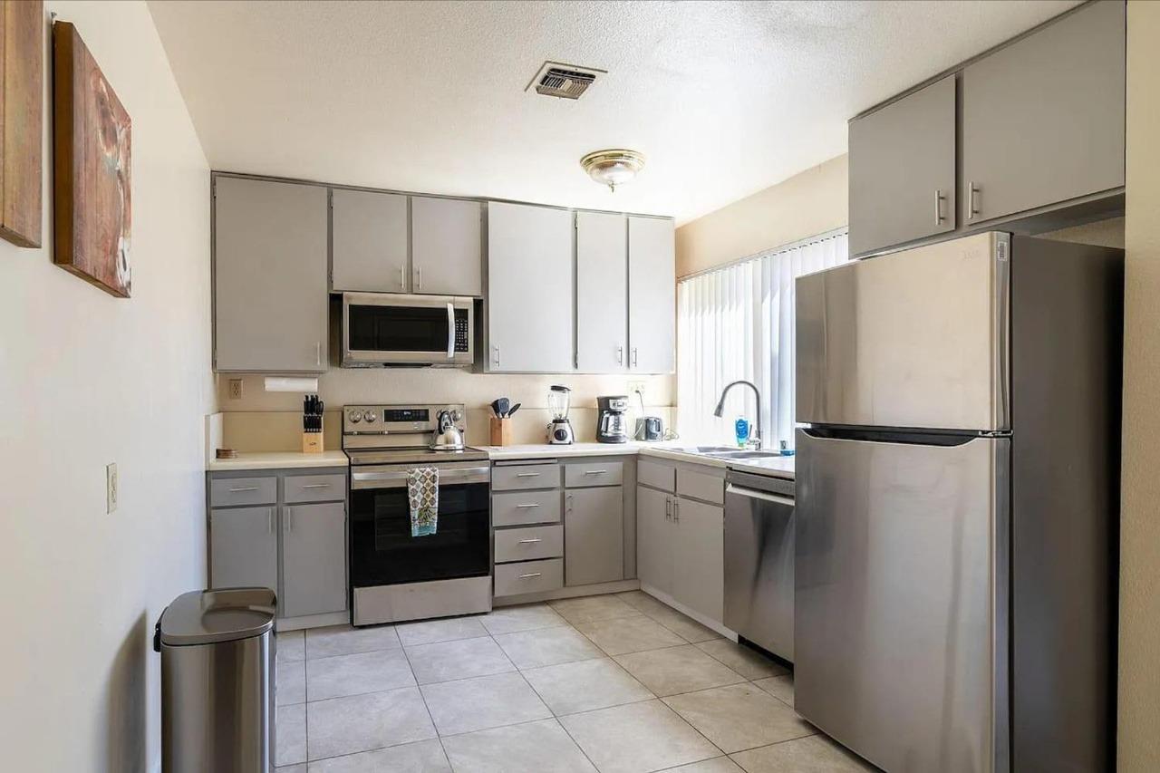 1504 Pierce Drive, Unit 102 Clovis, CA 93612 - Photo 3 of 20 a kitchen with stainless steel appliances a refrigerator sink and microwave