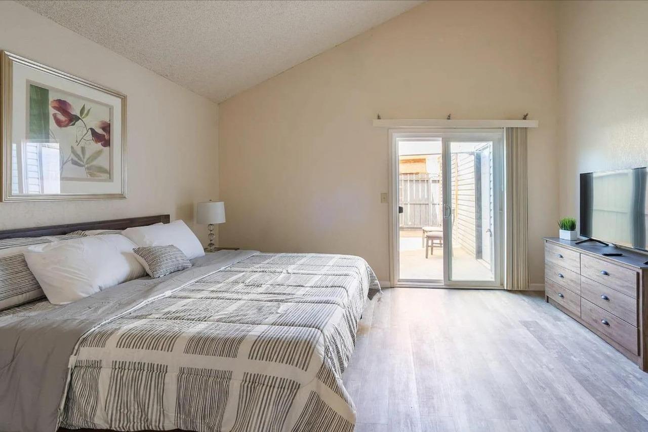 1504 Pierce Drive, Unit 102 Clovis, CA 93612 - Photo 7 of 20 a bedroom with a bed and a flat tv screen on the dresser