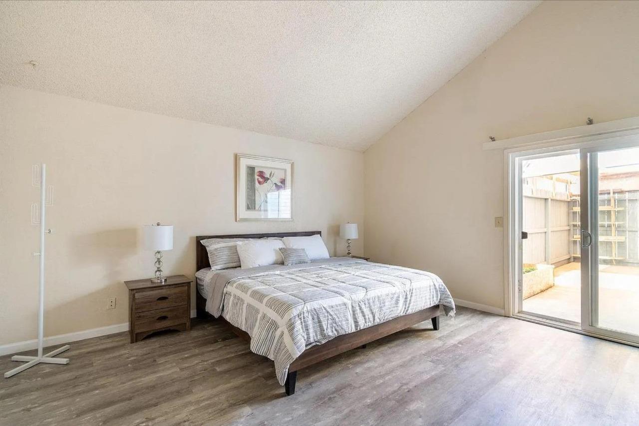 1504 Pierce Drive, Unit 102 Clovis, CA 93612 - Photo 8 of 20 a bedroom with a bed a mirror and a window