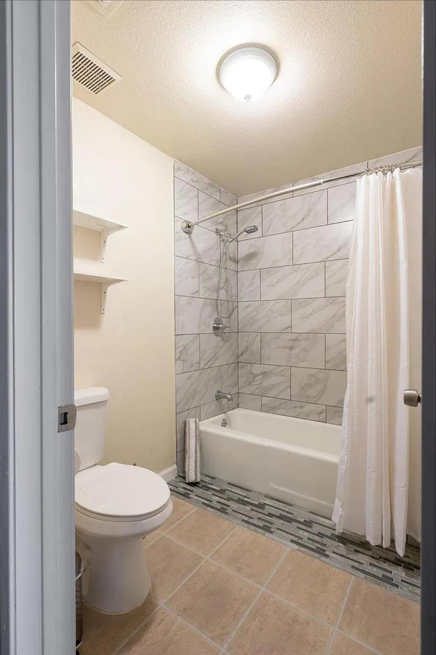 1504 Pierce Drive, Unit 102 Clovis, CA 93612 - Photo 9 of 20 a bathroom with a toilet and a shower