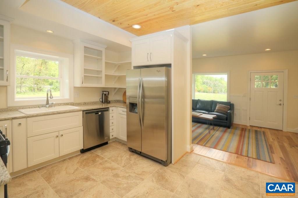 268 Dry Bridge Road Charlottesville, VA 22903 - Photo 18 of 36 a kitchen with a refrigerator sink and cabinets