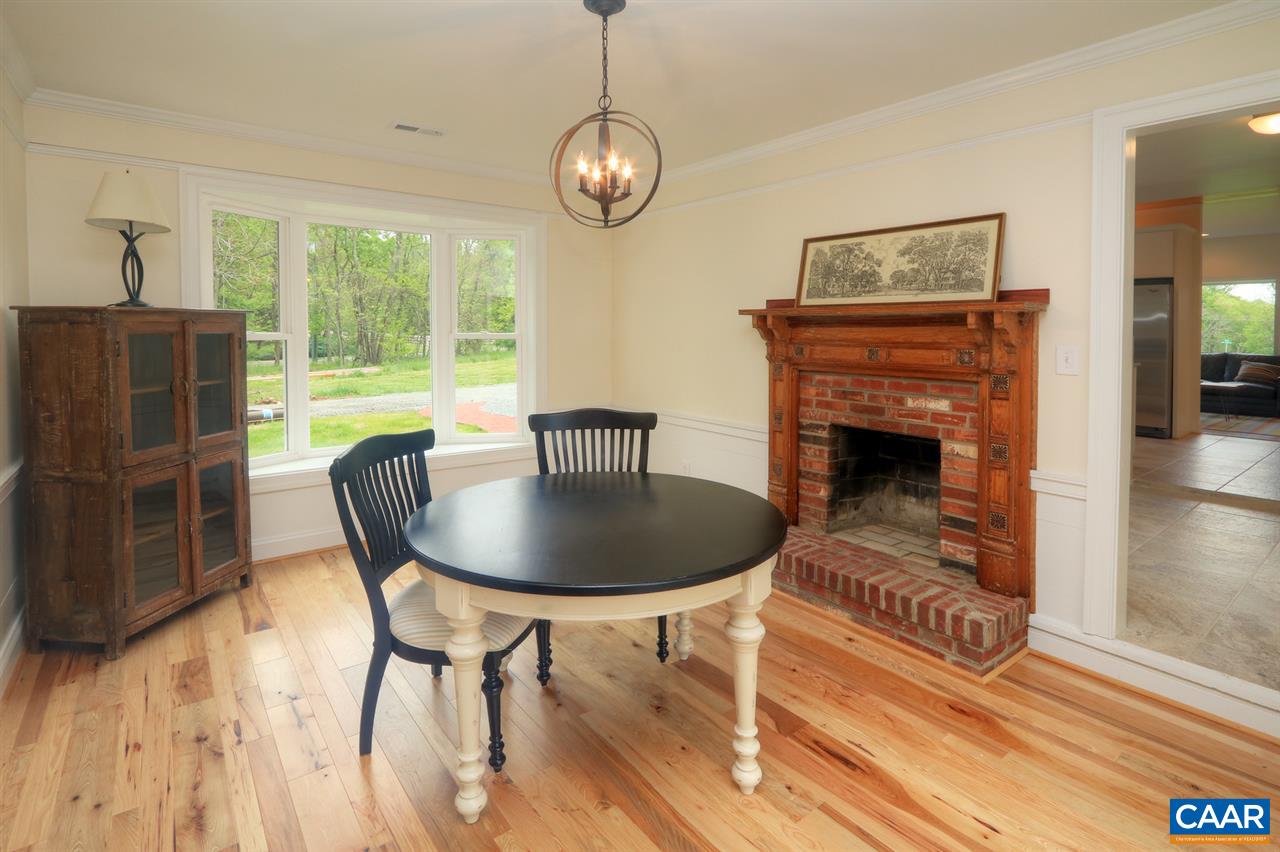 268 Dry Bridge Road Charlottesville, VA 22903 - Photo 22 of 36 a dining room with furniture a fireplace and wooden floor