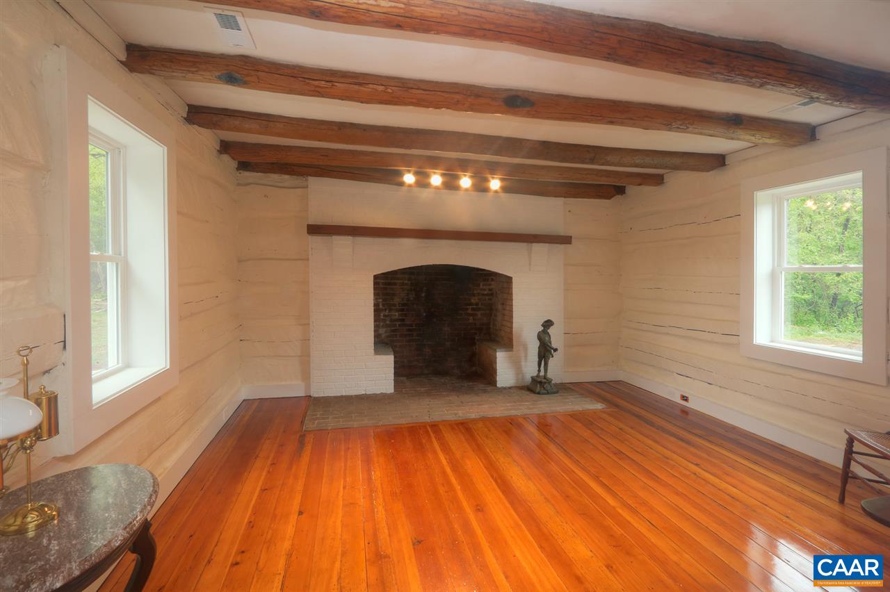 268 Dry Bridge Road Charlottesville, VA 22903 - Photo 25 of 36 a view of an empty room with wooden floor fireplace and a window